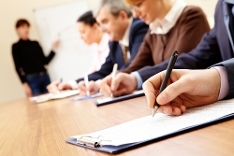 Business people undertaking an exam