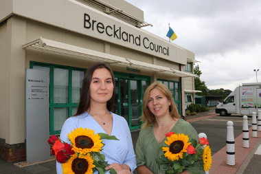 two women holding sunflower outside Breckland Council offices